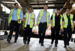 Travis Perkins employees smiling at a warehouse 