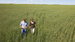 A man and a women standing in a field