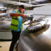 Image of Greene King brewing employee checking barrels of craft beer