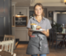 Young student waitress wearing jeans and a shirt, serving pub food at Greene King