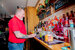 A smiling man stood behind the bar preparing drinks