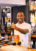 team leader at greene king behind the bar pouring a pint