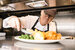 Greene King chef in the kitchen serving up food