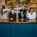 Greene King staff members behind the bar