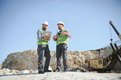 geologists discussing geology at a mining site