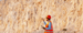 Mining engineer holding a tablet while directing a dumper truck in an open pit mine