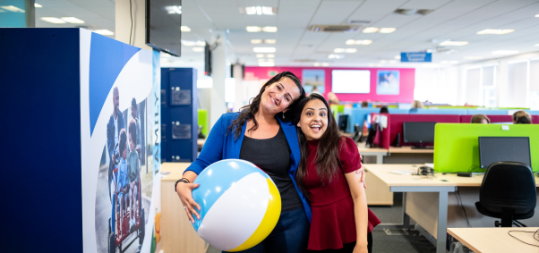 image of two laughing behind a desk