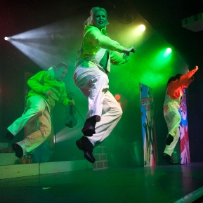 Image of a trio of dancers jumping in the air