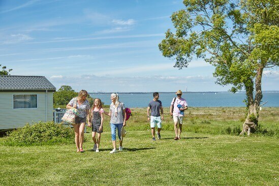 image of family walking by thorness bay beach