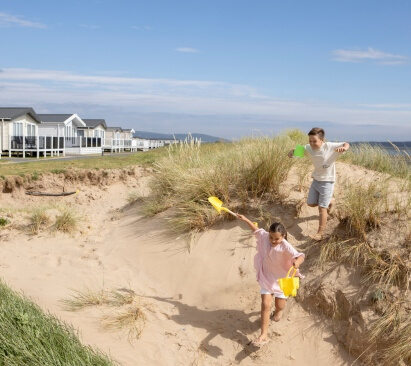 cleaner making a bed at Carmarthen Bay Holiday Park