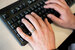 hands typing on a keyboard