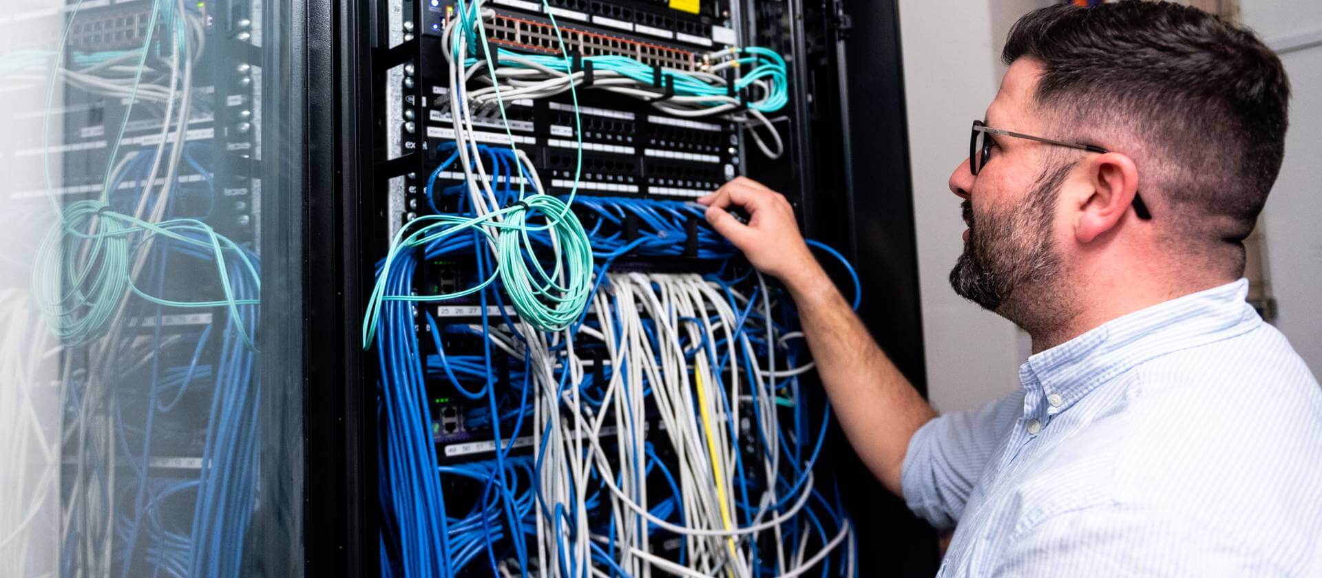 Image of a man rewiring IT