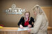 Parkdean guest experience advisor sat at a reception desk helping a guest.