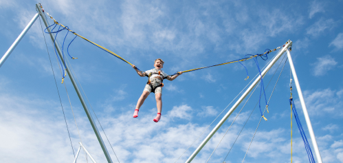 image of a child on a trampoline bungee jump