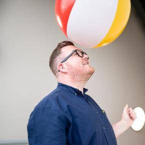 Image of a man with a beach ball on his head