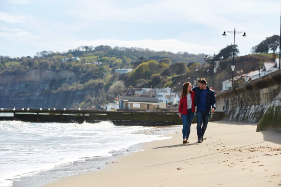 image of a couple walking on the beach