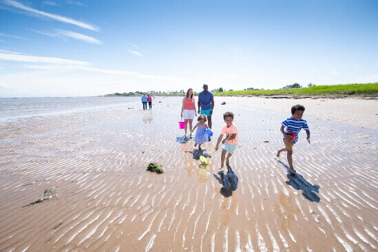 image of two adults and three children playing on Southerness beach