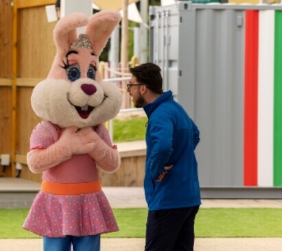 image of a parkdean employee speaking with a rabbit mascot
