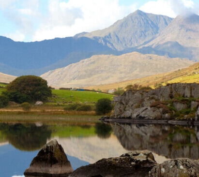 image of a lake and hills near towyn