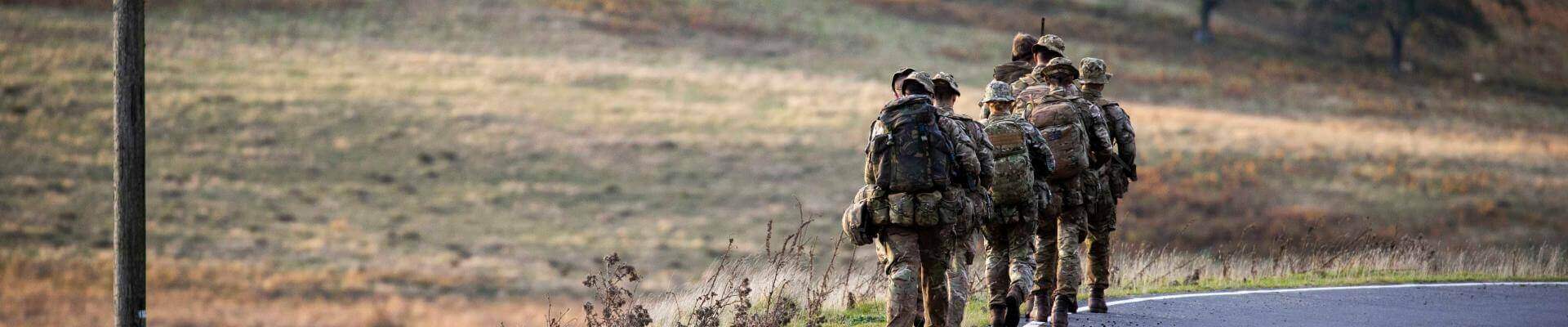 Image of soldiers walking by the side of a road