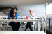 Two women sat at a table drinking coffee together and smiling.