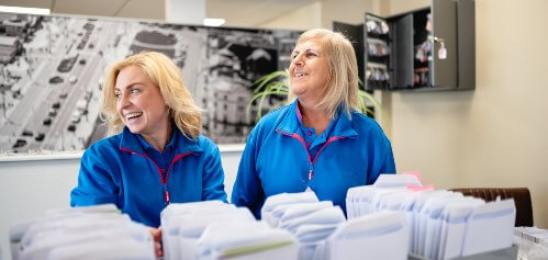 image of two women stood in the park dean office, smiling