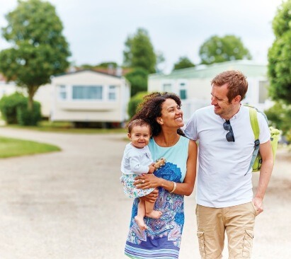 A family walking through Summerfields Holiday Park