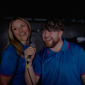 Image of two singers with a microphone