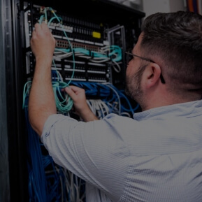 Image of a IT worker working with technical wires