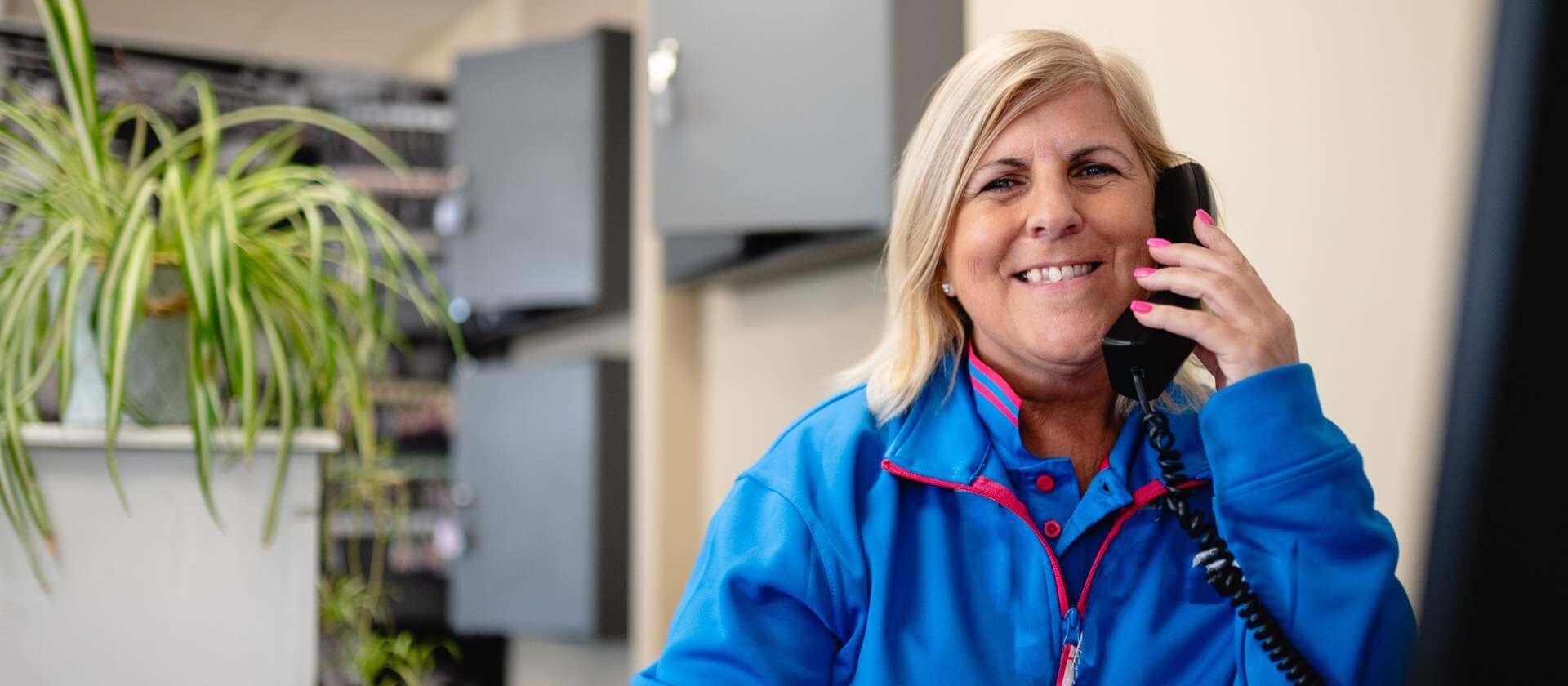 Image of a women on the phone, smiling