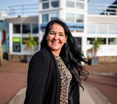 Image of Manager standing outside of a holiday park complex