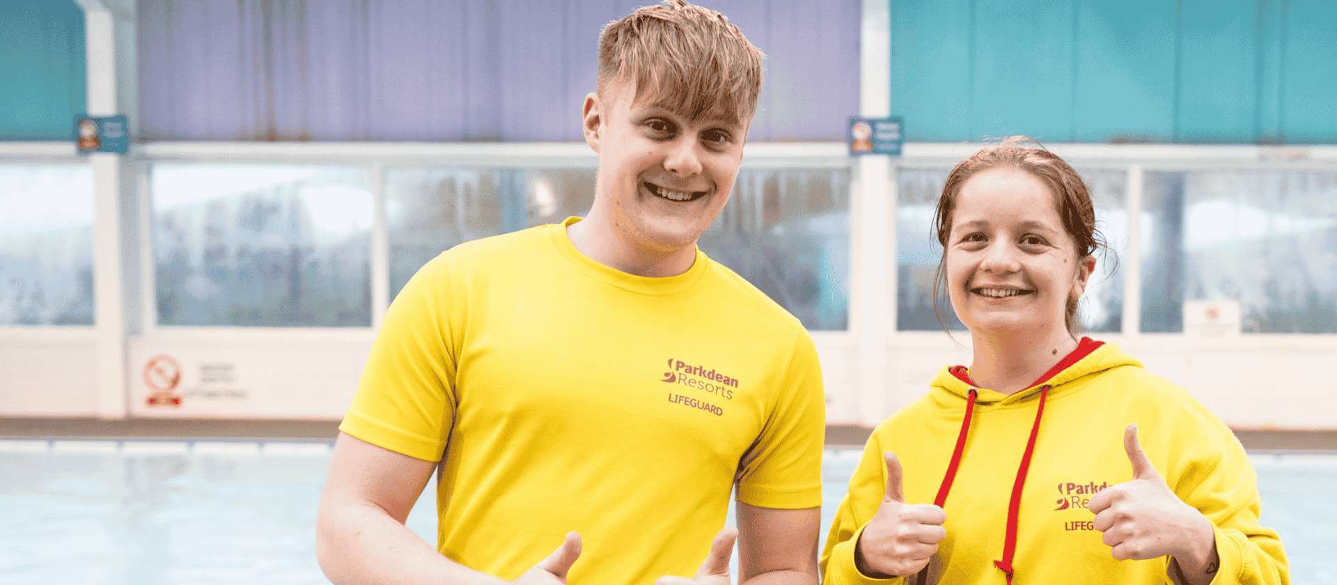 Image of two colleagues with their thumbs up and smiling