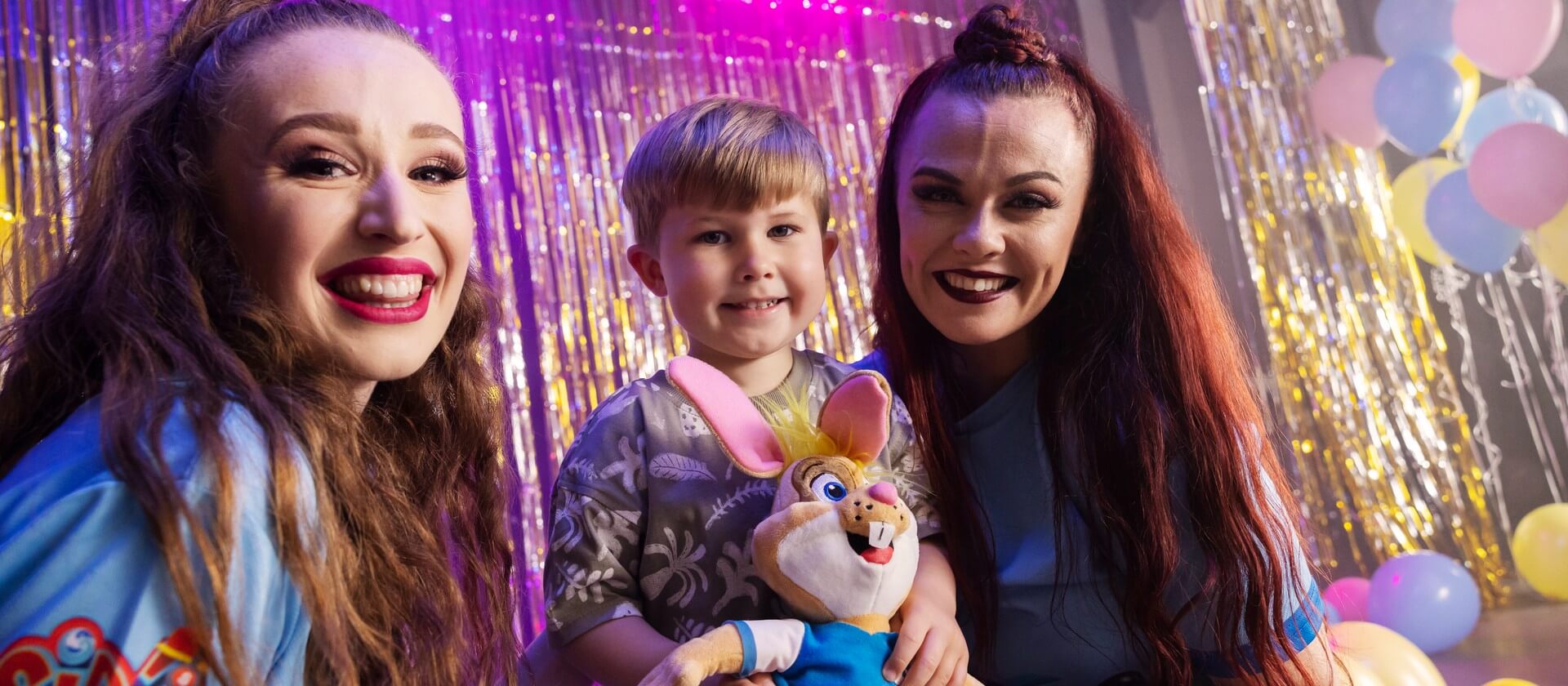 Image of two woman and a child smiling