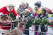 A lady dressed as santa with a smiling family and a reindeer!