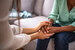 mental health technician holding hands with a patient 