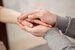 Mental health therapist making a difference - holding hands and comforting patient
