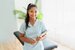 a portrait of clinical therapist holding a clipboard and smiling
