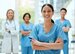 Portrait, medical and a woman nurse arms crossed, standing with her team in the hospital for healthcare. Leadership, medicine and teamwork with a female