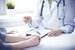 evidence based clinical care - therapist with a clipboard sitting at desk with patient opposite