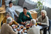 High angle view at group of senior people sitting at table together and smiling happily in senior living community home