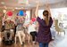 Portrait Of Senior Residents in Retirement Home Sitting In Lounge, doing an activity with an activities coordinator