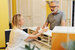 Resident speaking with a receptionist in front of house