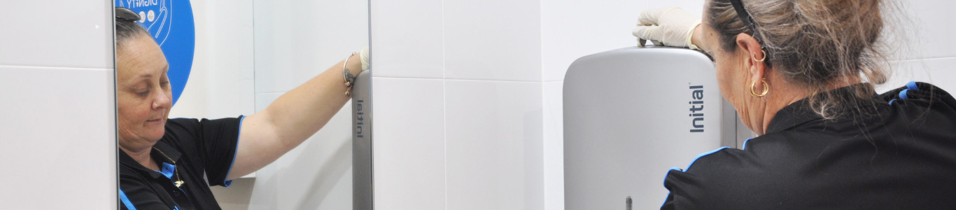 Initial technician servicing a paper towel dispenser