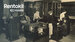Black and white photo of four women working with early office machinery, possibly accounting or computing machines, in a Rentokil office from an earlier era, with 'Rentokil 100 Years' logo overlaid.