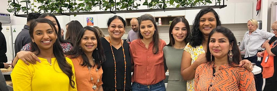 Group picture of female colleagues in office kitchen