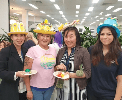 Female colleagues eating cake at a company event