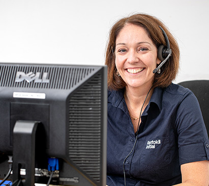 Customer service representative at her desk smiling