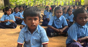 Children sitting in outdoor classroom
