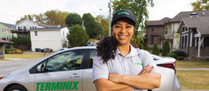 Terminix technician in front of her car