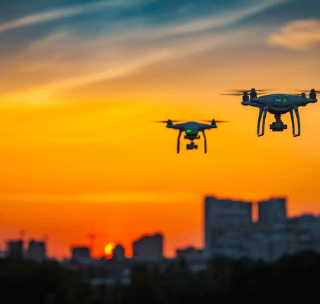 Drones overflying a city at dusk